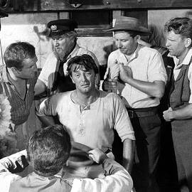 robert mitchum in the sundowners scene with ronald fraser and michael anderson jr. by Globe Photos