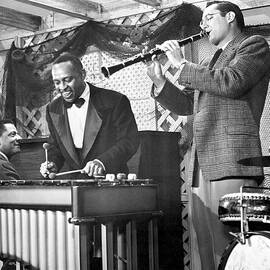 smiling lionel hampton playing vibraphone with benny goodman by Globe Photos
