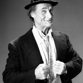 smiling sid caesar standing in studio by Globe Photos