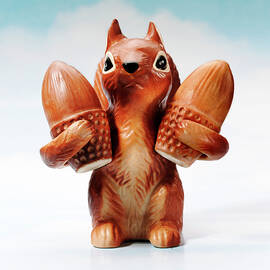 Squirrel Holding Two Acorns by CSA Images