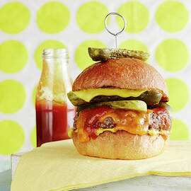 Still Life Of Cheeseburger With Retro Background by Brett Stevens
