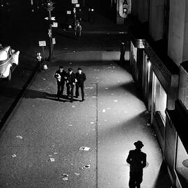 Trio of sailors walking arm in arm down a dimly lit street near Times Square at 2:00 AM searching vainly for fun in the curfew closed city. by Herbert Gehr