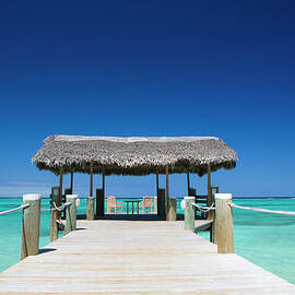 Two Chairs On End Of Dock With Palapa by Justin Lewis