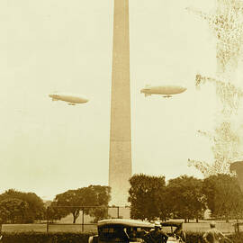 U.S. Army blimps, the T.C. 5 and T.C. 9 from Langley Field, Va. passing over the Washington Monument during a practice flight by 