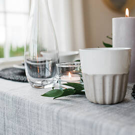 Water Glass And Candle On A Romantic Dinner Table For Two by Cavan Images