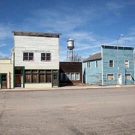 Water Tower And Vacant Business by Milehightraveler