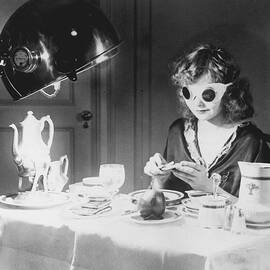 Woman Eating Meal Under An Ultraviolet by Bettmann