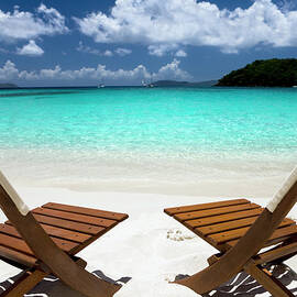 Wooden Chairs On A Beach In The by Cdwheatley