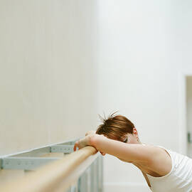 Young Woman Leaning Against Rail In by Nick White