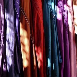 Dappled sunlight filters down on clothing  by Steve Estvanik
