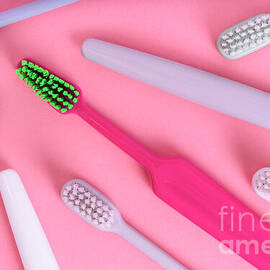 Different pastel tooth brushes pattern on color background. Many by Jelena Jovanovic