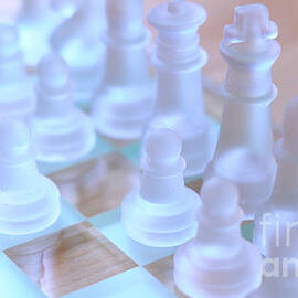 Macro closeup of glass chess pieces in natural light. by Milleflore Images