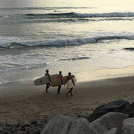 Pacific Palisades Surfers Carrying Their Boards Along the Beach Los Angeles California USA 2016 by John Shiron