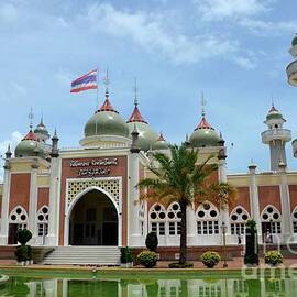 Pattani central mosque courtyard with pond minarets and Thai flag Thailand by Imran Ahmed