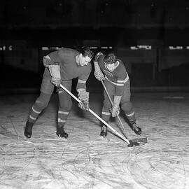 1940s 1950s ice hockey players fighting for the puck by Panoramic Images
