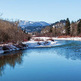 A blue mountain river in Montana at wintertime by Tatiana Travelways
