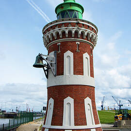 A lighthouse with a fog bell by Juergen Hess