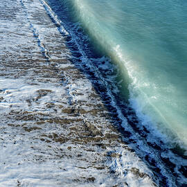 Aerial view of ocean waves breaking on a sandy beach. Nature background by Michalakis Ppalis