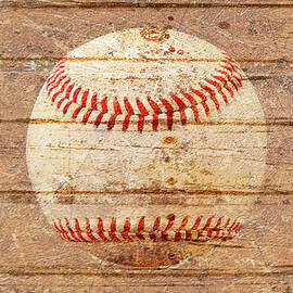 Baseball on weathered timber. by Joe Vella