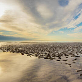 Beach reflections by Stuart C Clarke