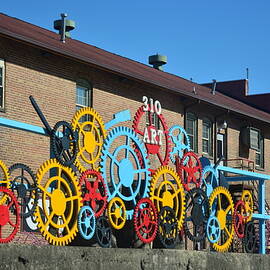Brightly Painted Cog Wheels, Ashville Art Centre  by Bill Lee