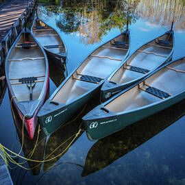 Canoes Floating at the Dock by Debra and Dave Vanderlaan