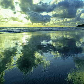 Clouds reflected in wet sand by Jeff Swan