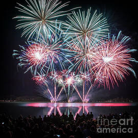 Colorful big fireworks on river with crowd silhouette by Gregory DUBUS