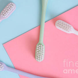 Different pastel tooth brushes pattern on color background. Many by Jelena Jovanovic