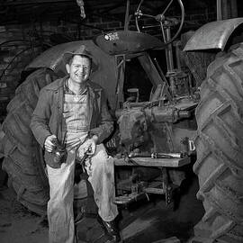 Farmer working on his tractor 1946 by The Harrington Collection