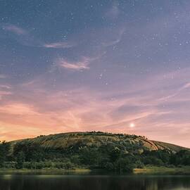 Full moon illuminated enchanted rock and clouds for an interesting long exposure - calm body of water and mountain - Enchanted Rock, United States by Julien