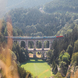 Kalte Rinne railway viaduct and a passing train in Semmering, Austria by Vaclav Sonnek