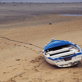 Little boat on a beach in the Algarve Portugal by Western Exposure