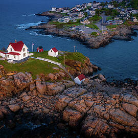 Looking at the Rocky Maine Coast upon which sits Nubble Lighthoue by Jeff Folger