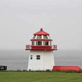 Maritime lighthouse on a cloudy day by Nadine Mot Mitchell
