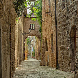 Medieval cobble stone street in Tuscany by Patricia Hofmeester