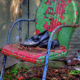 Pull up a Chair and Sit a While - Leather Shoes resting on colorful peeling chair at abandoned farm by Peter Herman