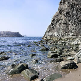 Rock spackled shore by Jeff Swan