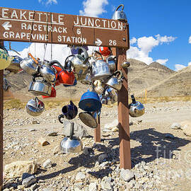 Teakettle Junction and road sign covered by kettles and pans, Death Valley National Park, California