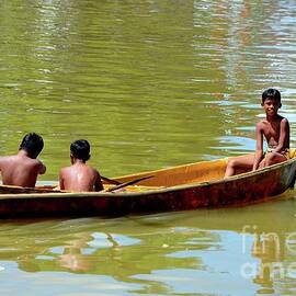 Thai boys on boat in fish harbor Pattani Thailand by Imran Ahmed