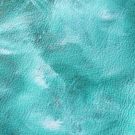 Turquoise and white oil paint brush mixed on leather texture  by Dorin Puha