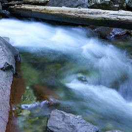 Water rushing over rocks by Jeff Swan