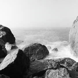 Waves spreading across rocks  by Jeff Swan