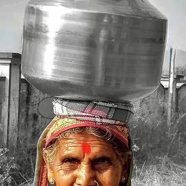 Woman carrying  water by Kalpana Hebbar