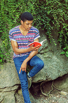 Alexander Image - Young African American Man reading book, traveling, relaxing at Alexander Image - Young African American Man reading book, traveling, relaxing at