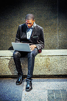 Alexander Image - Young African American Man working on laptop computer outside in Alexander Image - Young African American Man working on laptop computer outside in