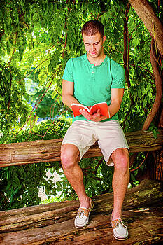 Alexander Image - Young American Man reading book, traveling in New York in summer Alexander Image - Young American Man reading book, traveling in New York in summer