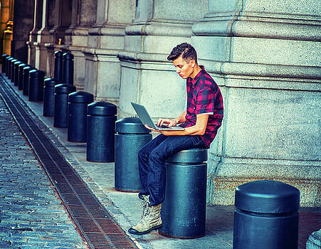 Alexander Image - Young American Man working on computer on street in New York Alexander Image - Young American Man working on computer on street in New York