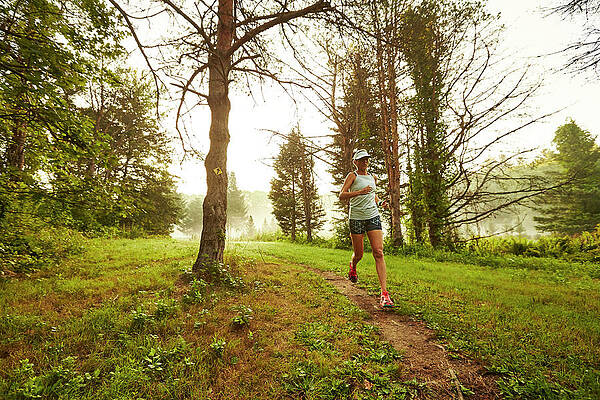Wall Art - Photograph - A Female Trail Runner Running #1 by Josh Campbell
