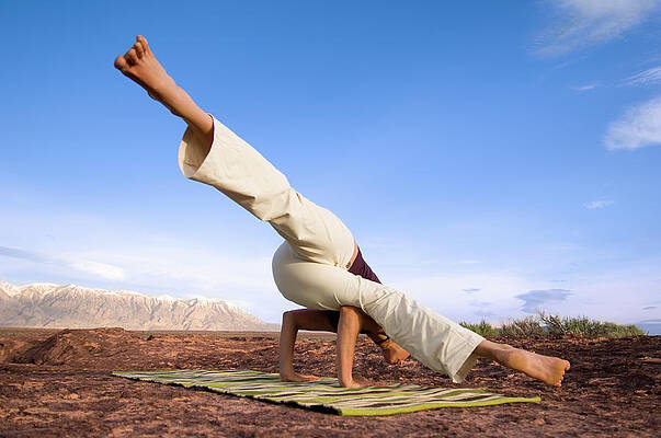Wall Art - Photograph - A Woman Practicing Yoga On A Dry Lake #1 by Lars Schneider